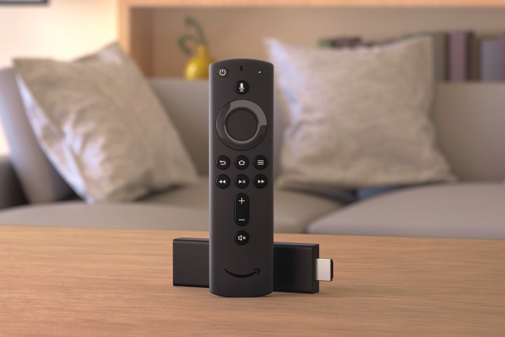 Amazon Fire TV Stick and remote sit on a living room table.