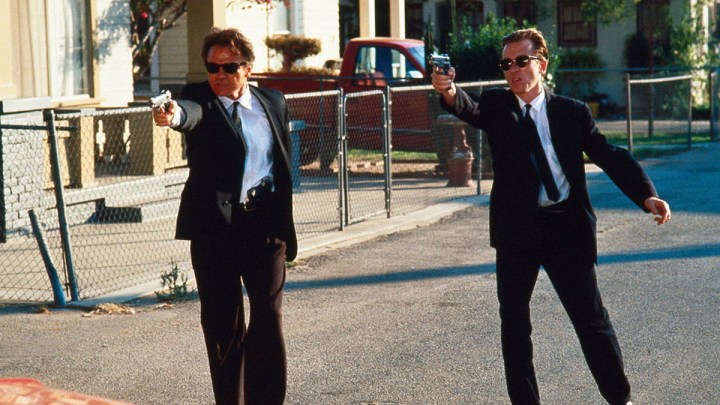 Harvey Keitel and Tim Roth as Mr. White and Mr. Orange aiming guns in the same direction in the film Reservoir Dogs.