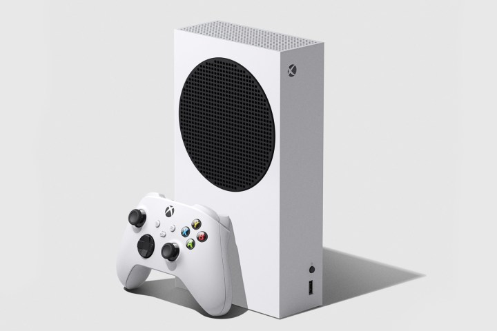 An Xbox Series S stands upright next to an Xbox wireless controller.
