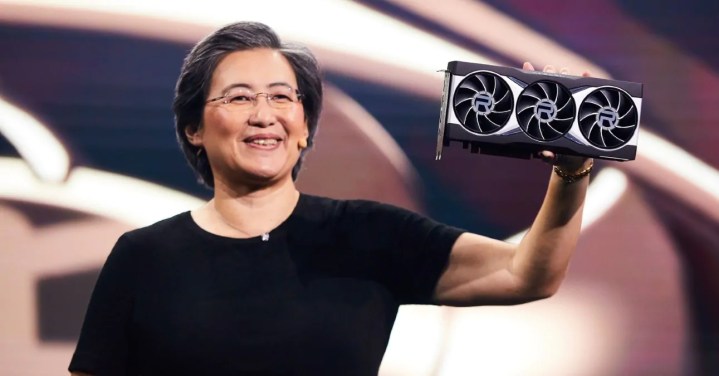 AMD CEO Lisa Su is pictured holding an AMD Radeon RX 6900 XT graphics card.
