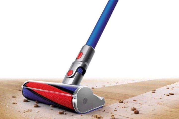 Dyson V7 Absolute Cordless Vacuum picks up crumbs off a hardwood floor.