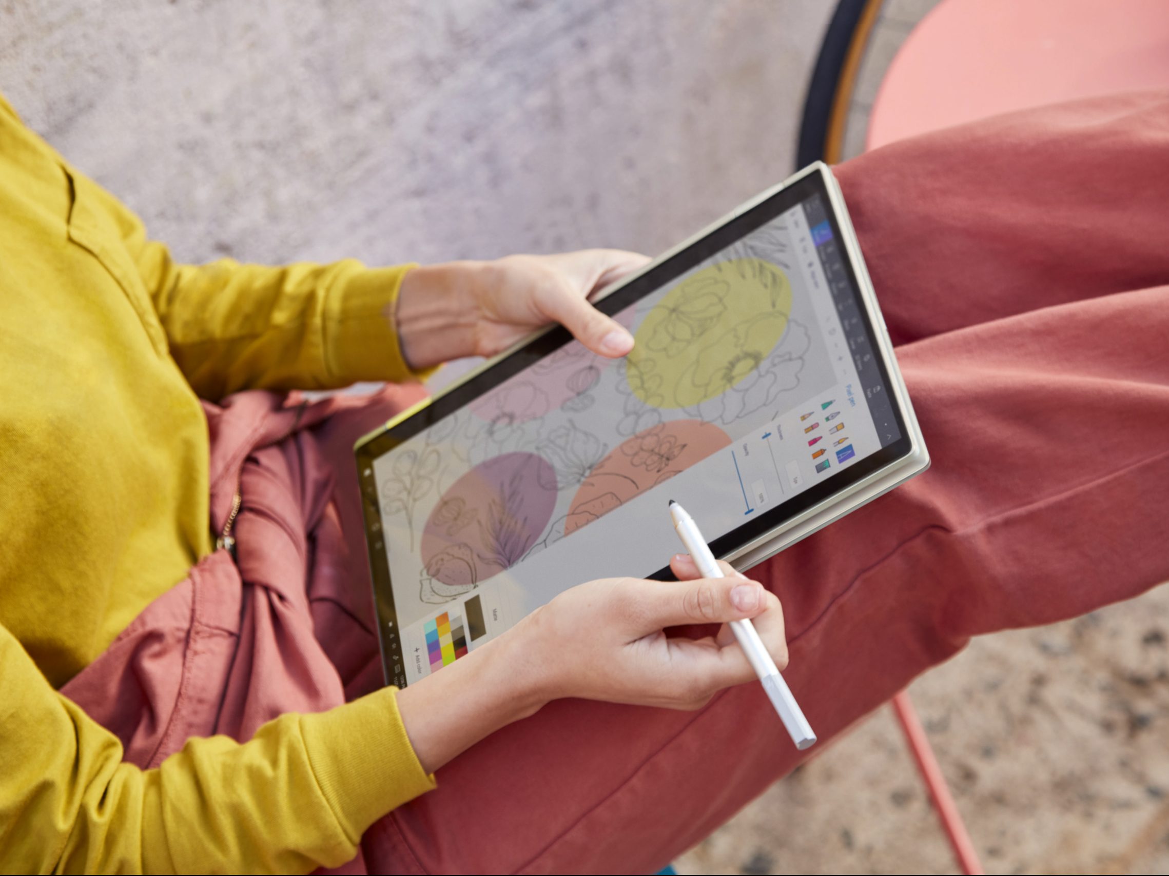 A woman using the HP Envy x360 13 2-in-1 in tablet mode.