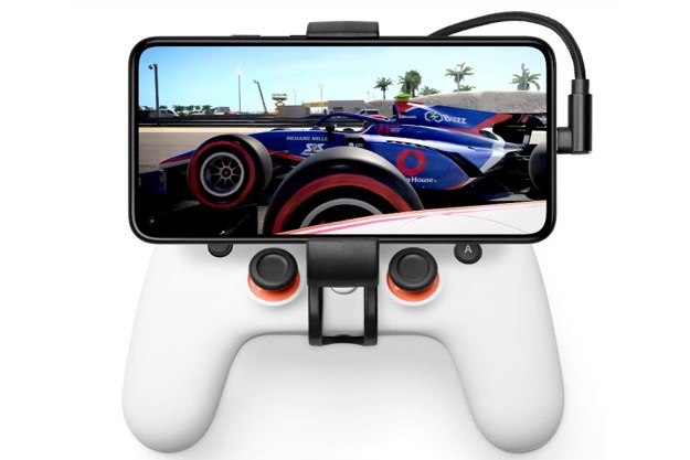 Breaking News Google Pixel mobile phone held by a Stadia controller grip.