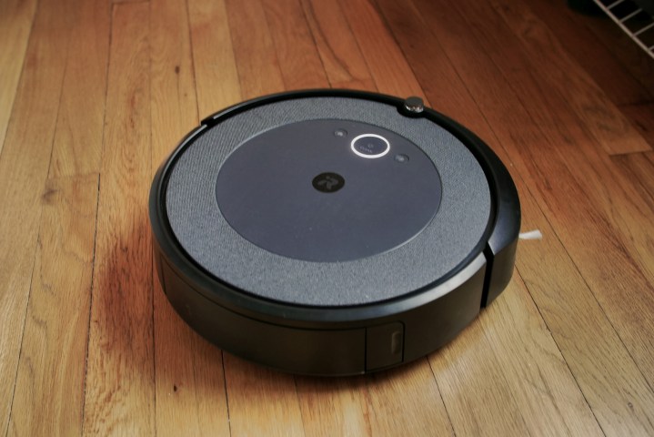 iRobot Roomba i3 Plus on on a hardwood floor.