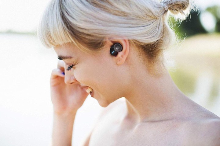 woman wearing JBL earbuds