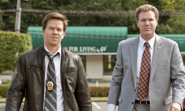 Mark Wahlberg and Will Ferrell stand next to each other in The Other Guys.