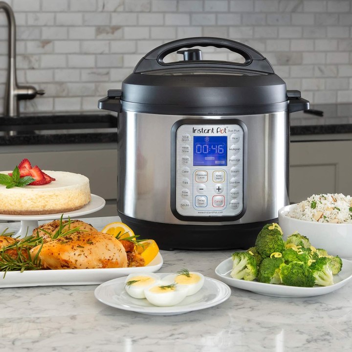 Instant Pot Duo Plus on a kitchen countertop surrounded by food.