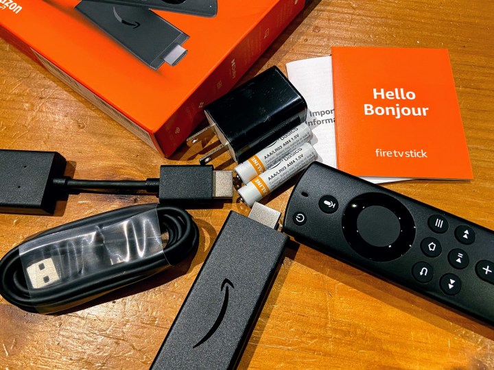 An Amazon Fire TV Stick Lite with its accessories and box.