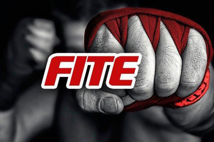 Логотип FITE TV с завернутым кулаком на заднем плане.