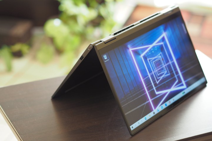 The Lenovo Yoga 7i in tent mode sits on a table.