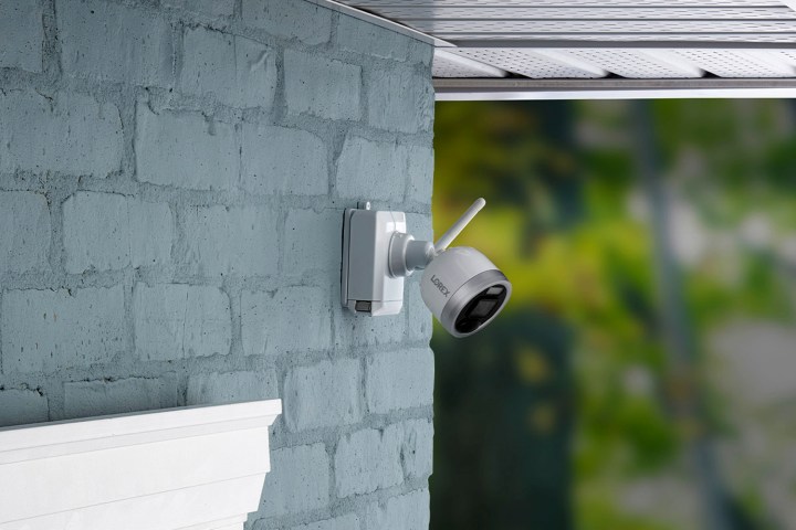 Lorex 1080p wire-free camera security system mounted on a brick wall.