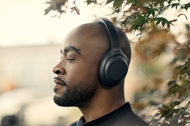 A man wearing the Sony WH-1000XM4 wireless headphones.