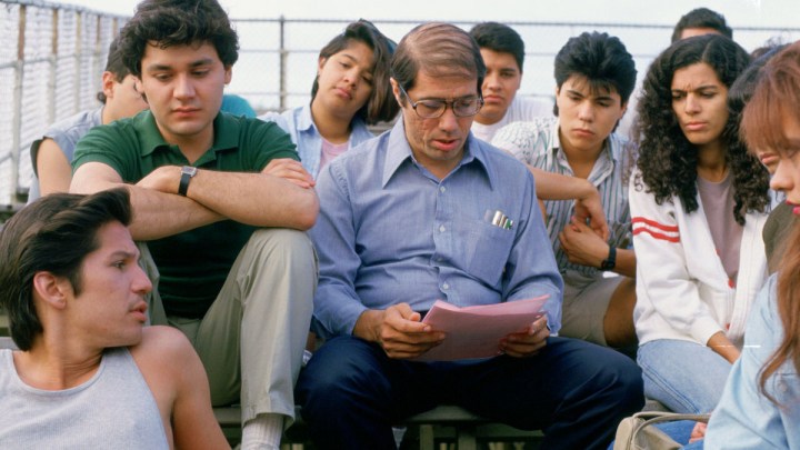 Edward James Olmos as Jaime Escalante surrounded by his students in the movie Stand and Deliver.