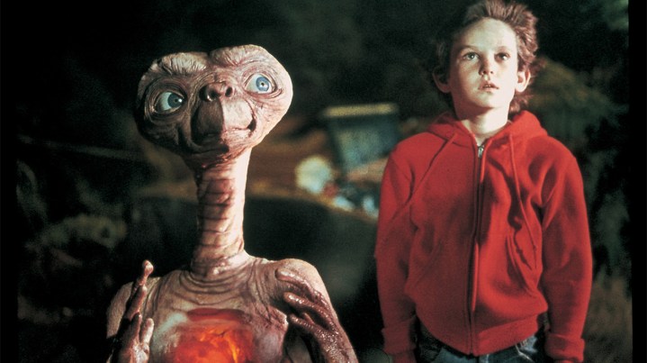 Elliot stands next to his alien friend in E.T. the Extra-terrestrial.