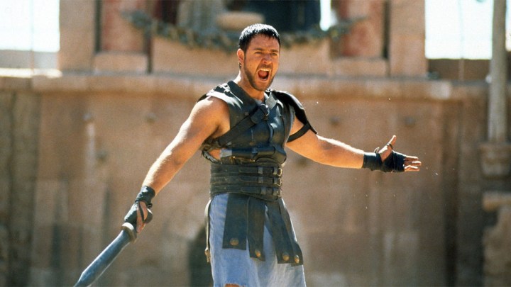 Russell Crowe extiende sus manos en la arena para Gladiator.