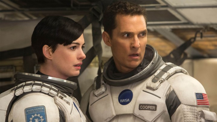 Matthew McConaughey and Anne Hathway curiously stare next to each other in a scene from Interstellar.