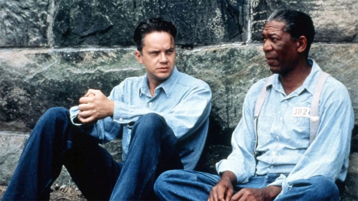 Andy and Red sit on the ground in The Shawshank Redemption.