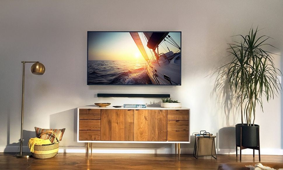 A Vizio 65 inch TV hangs on a living room wall.