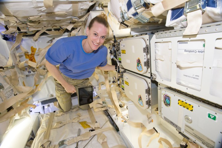 NASA astronaut Kate Rubins poses next to cold stowage Polar Facilities in the SpaceX CRS-9 cargo Dragon spacecraft in 2016. The new cargo spacecraft has more powered locker space, enabling additional cold stowage space.