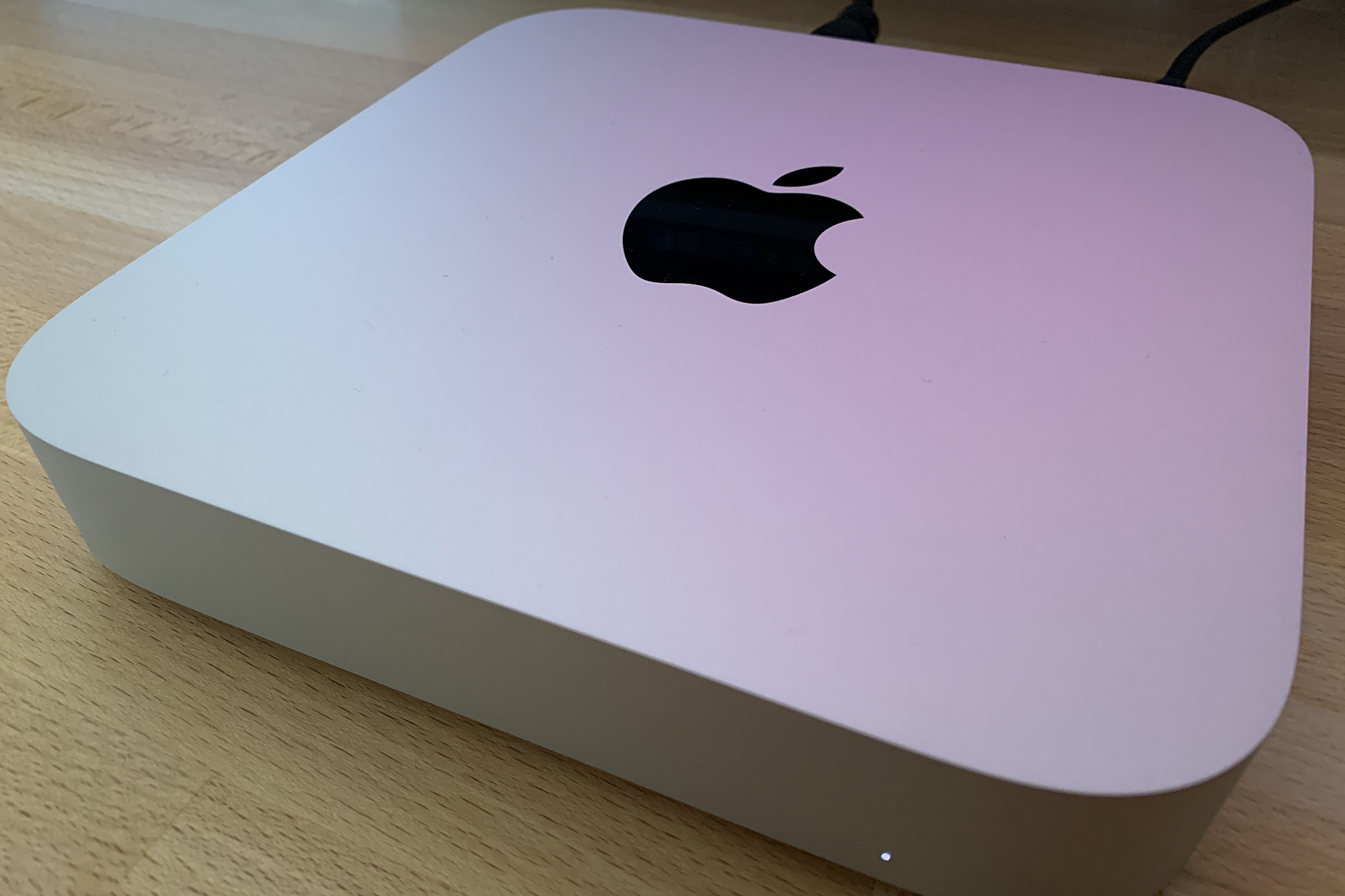 The Mac Mini M1 sitting on a desk.