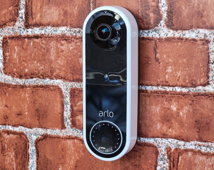 Arlo Essential Wireless Doorbell mounted on brick