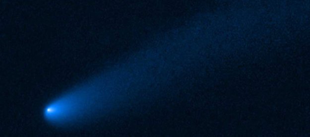 NASA's Hubble Space Telescope snapped this image of the young comet P/2019 LD2 as it orbits near Jupiter’s captured ancient asteroids, which are called Trojans. The Hubble view reveals a 400,000-mile-long tail of dust and gas flowing from the wayward comet's bright solid nucleus.