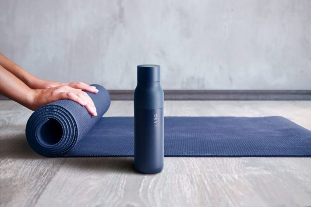 LARQ watter bottle sitting beside a yoga matt
