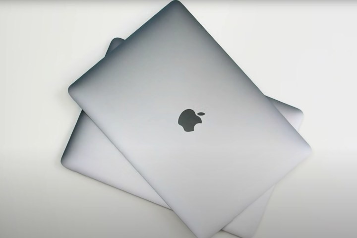 A stack of MacBooks is pictured from the top down.