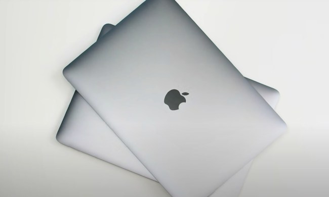A stack of MacBooks is pictured from the top down.