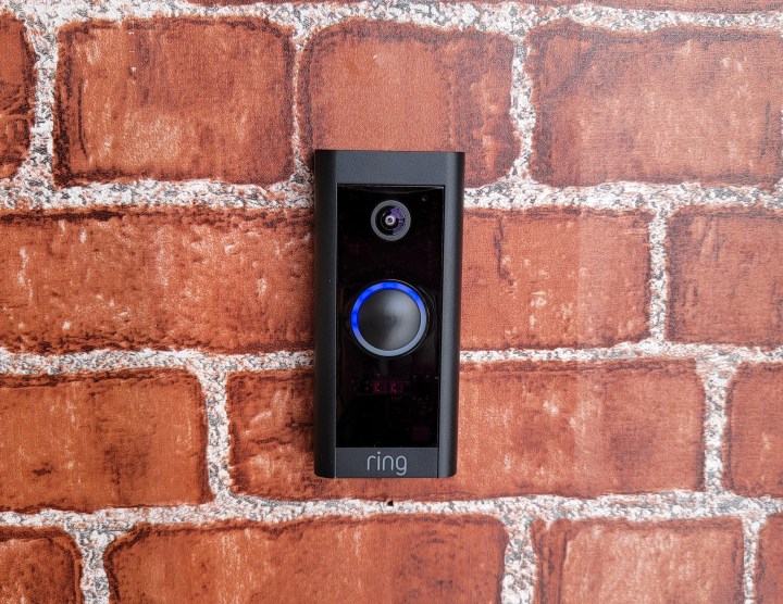Ring Video Doorbell Wired mounted on a brick wall.