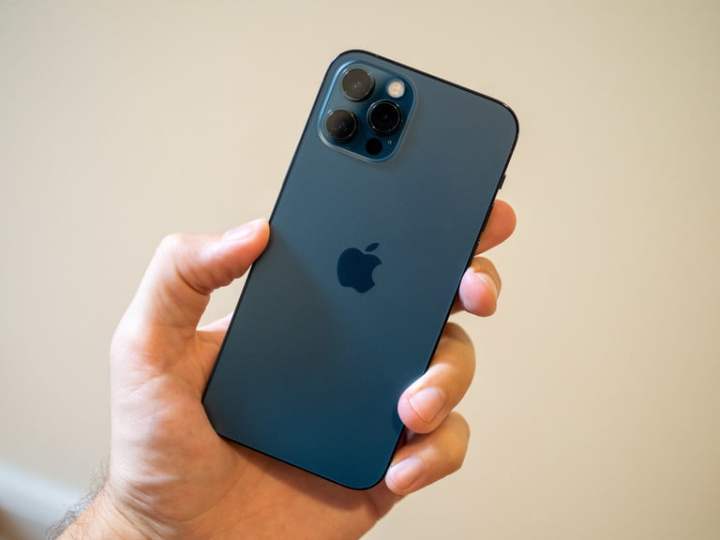The back of the iPhone 12 Pro being held by someone.