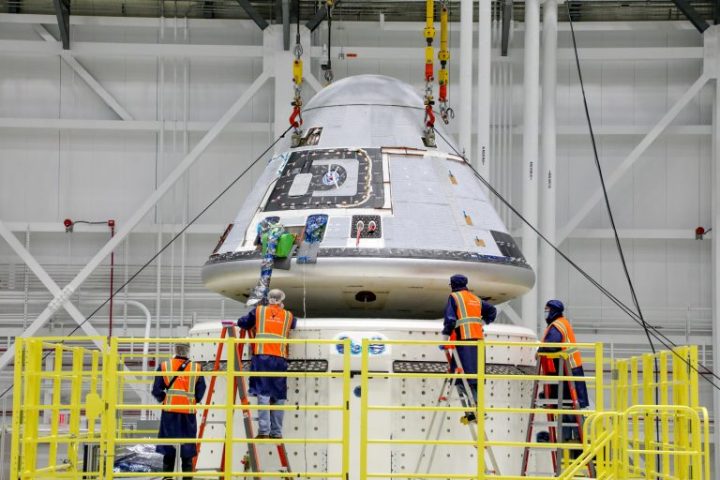 Technicians observe Boeing’s Starliner crew module being placed on top of the service module in the Commercial Crew and Cargo Processing Facility at NASA’s Kennedy Space Center in Florida on Jan. 14, 2021. The Starliner spacecraft is being prepared for Boeing’s second Orbital Flight Test (OFT-2). As part of the agency’s Commercial Crew Program, OFT-2 is a critical developmental milestone on the company’s path to fly crew missions for NASA. 