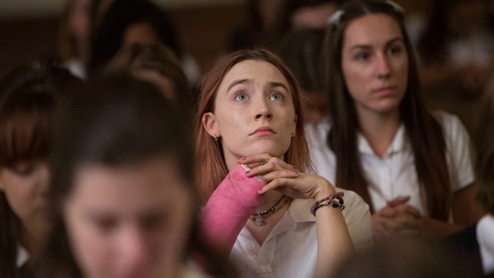 Saoirse Ronan looking up in church in Lady Bird.