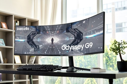 The Samsung Odyssey G9 monitor on a desk in an apartment.