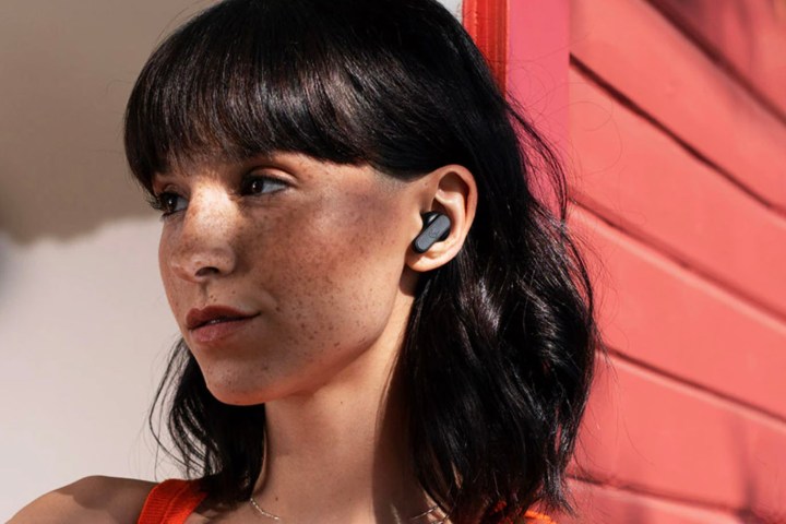 A woman wearing the Skullcandy Dime wireless earbuds.