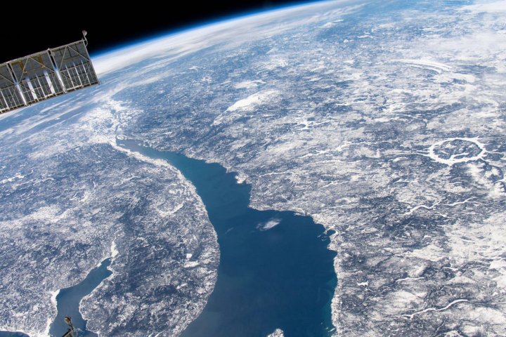 This image was captured by the International Space Station Expedition 59 crew as they orbited 400 kilometers above Quebec, Canada. Right of center, the ring-shaped lake is a modern reservoir within the eroded remnant of an ancient 100 kilometer diameter impact crater, which is over 200 million years old.