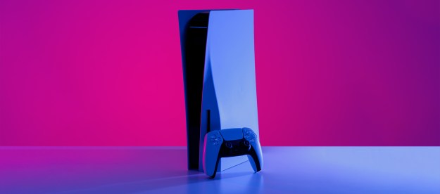A PS5 standing on a table, with purple lights around it.