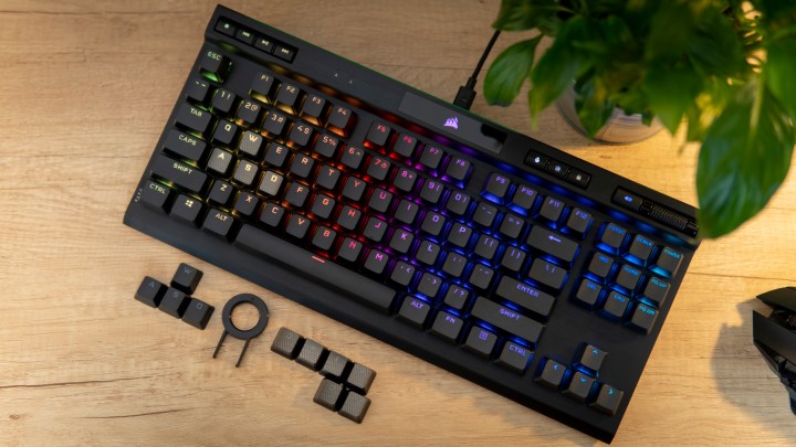 The Corsair K70 RGB TKL sitting on a table with accessories.