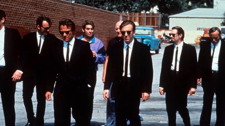 Men in suits walk down the road in Reservoir Dogs.