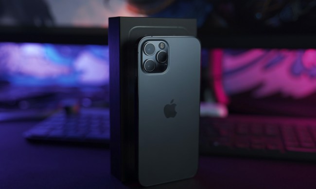 The iPhone 12 under neon lighting.