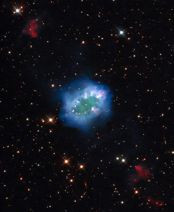 The interaction of two doomed stars has created this spectacular ring adorned with bright clumps of gas ­– a diamond necklace of cosmic proportions. Fittingly known as the “Necklace Nebula,” this planetary nebula is located 15,000 light-years away from Earth in the small, dim constellation of Sagitta (the Arrow).