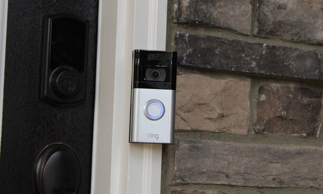 The Ring Video Doorbell 4 beside a door.