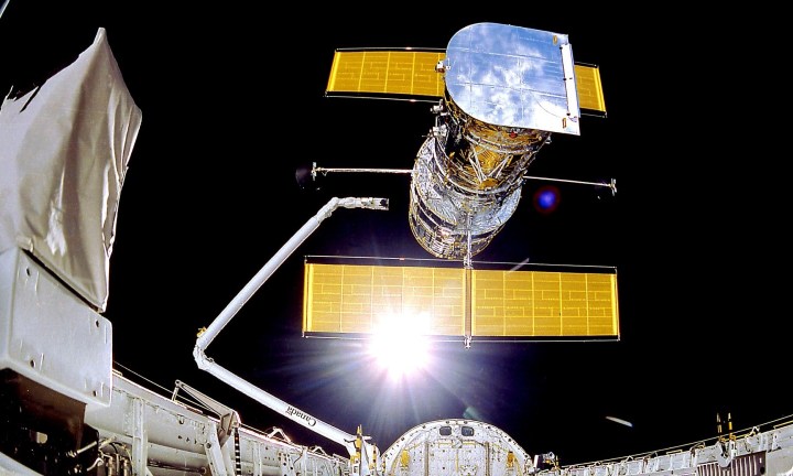 The Hubble Space Telescope is deployed on April 25, 1990 from the space shuttle Discovery. Avoiding distortions of the atmosphere, Hubble has an unobstructed view peering to planets, stars and galaxies, some more than 13.4 billion light years away.