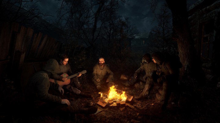 Survivors around a camp fire in Stalker 2.