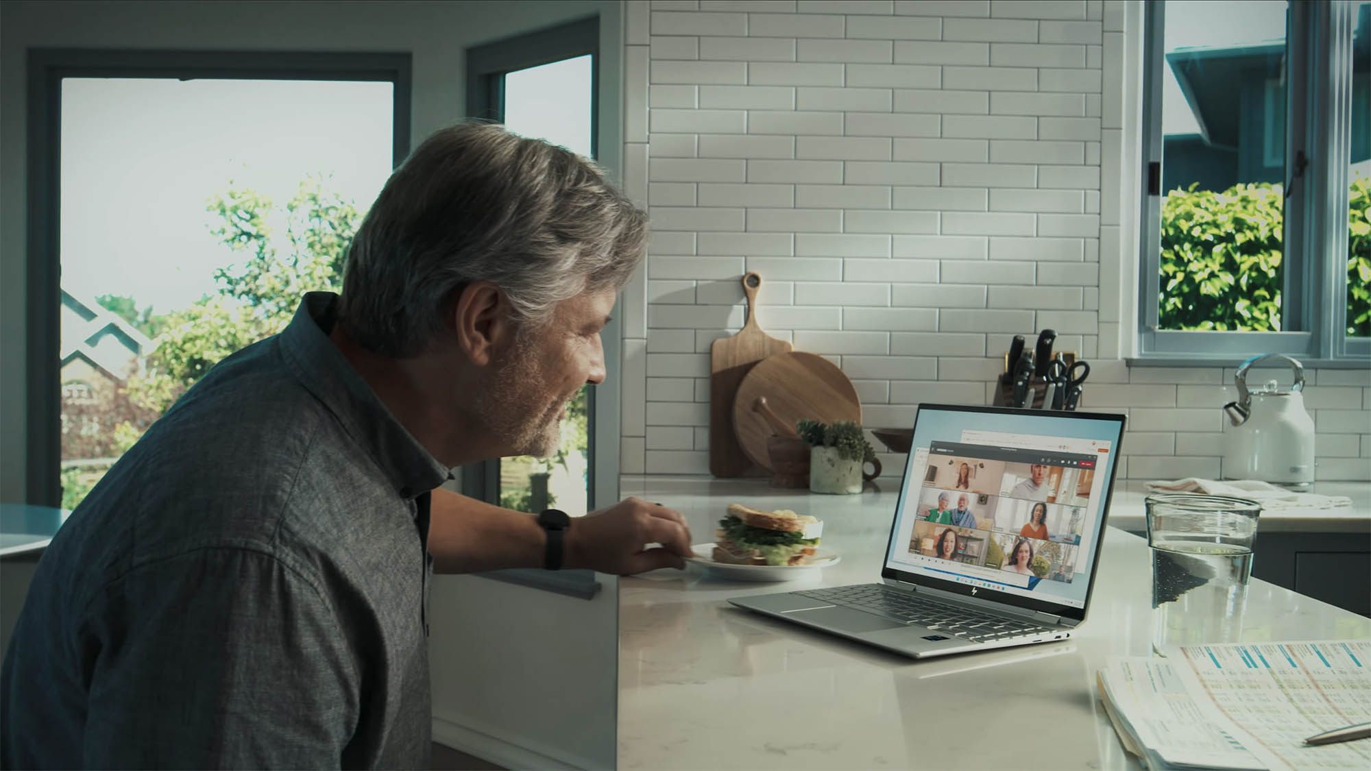 Man uses Microsoft Teams on a laptop in order to video chat.