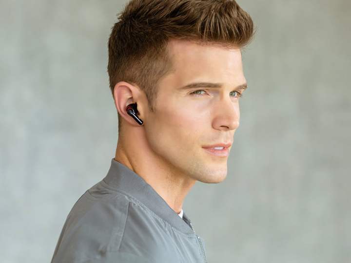A man wearing the Tribit Flybuds.
