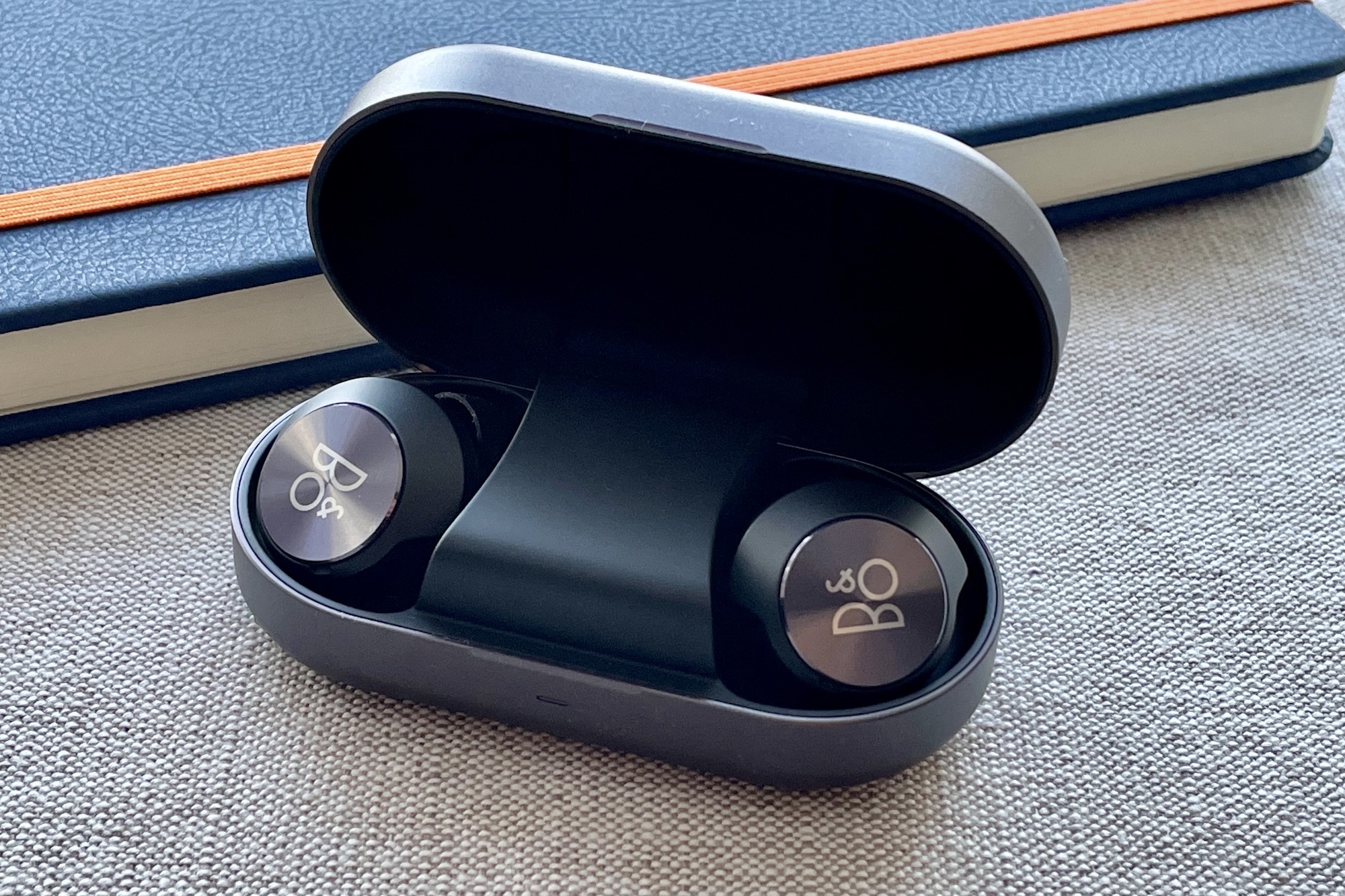 Beoplay EQ earbuds in the case.