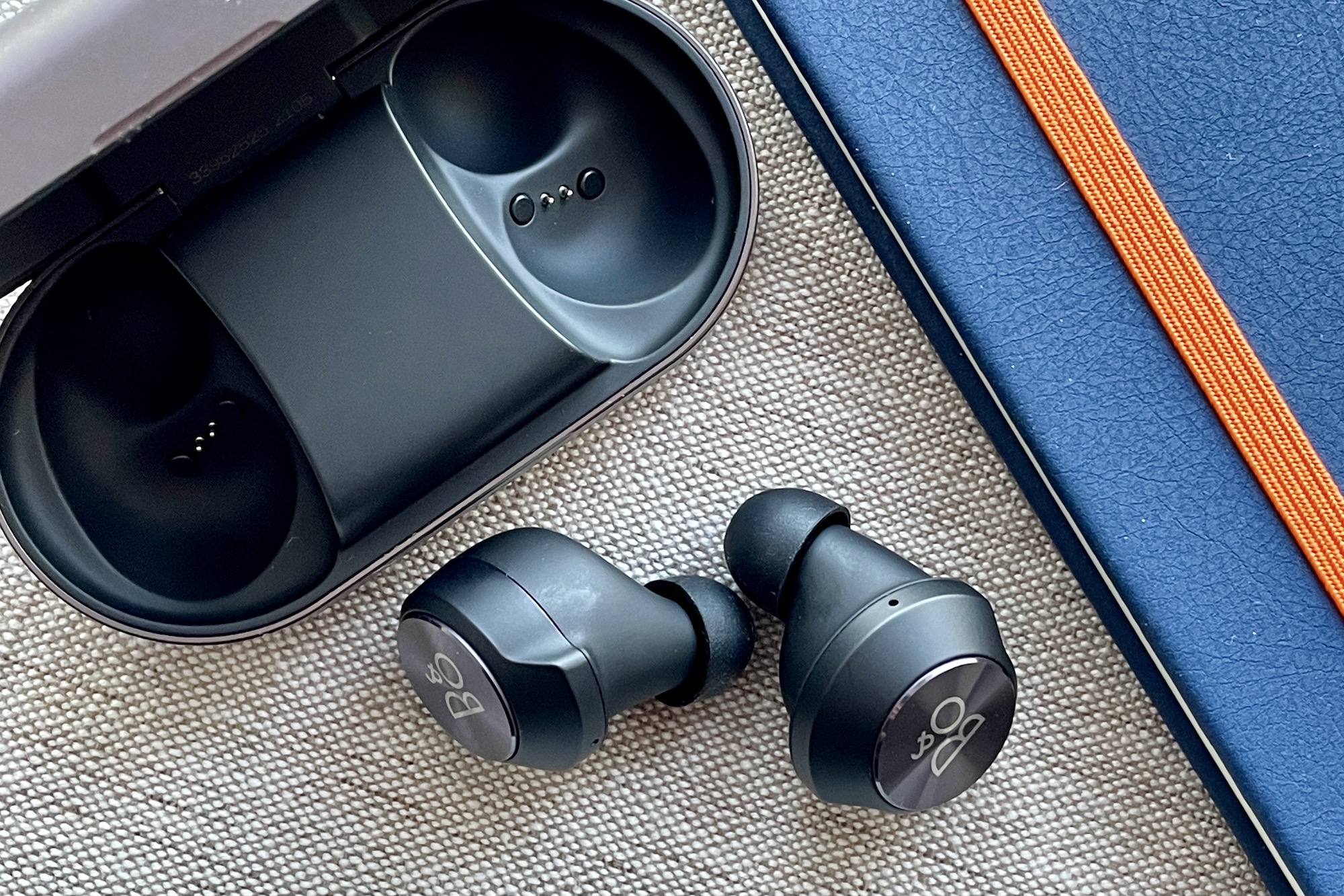 Beoplay EQ earbuds out the case, seen from the side.