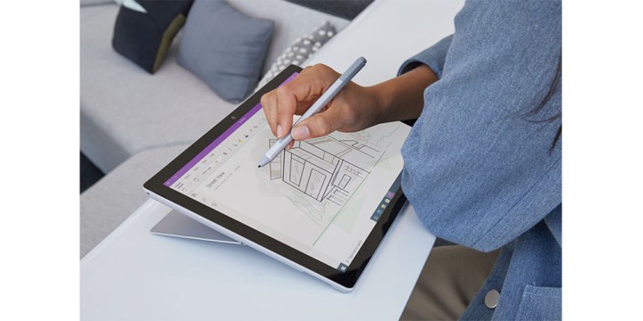 Microsoft Surface Pro 7 in tablet mode with someone using a stylus on it.