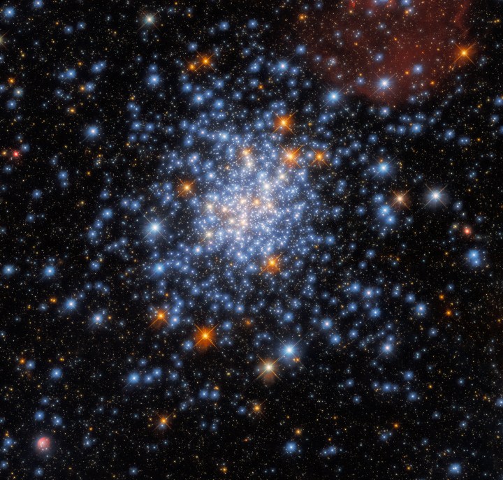This image taken with the NASA/ESA Hubble Space Telescope depicts the open star cluster NGC 330, which lies around 180,000 light-years away inside the Small Magellanic Cloud. The cluster – which is in the constellation Tucana (the Toucan) – contains a multitude of stars, many of which are scattered across this striking image.